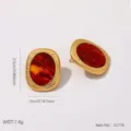 Detail view of oval titanium steel earrings with golden brushed texture and amber resin - Embossed Square Gold Edge (BJGE1778)