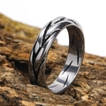 Detail of industrial steel ring with black diagonal grooves on rugged bark - US 7 / Steel