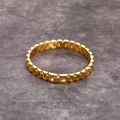 Minimalist gold titanium steel watch-band style bracelet on a textured stone surface - Gold