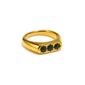 Dettaglio macro dell'anello in acciaio dorato con tre zirconi verdi incastonati - US 6 / Oro Zircone Verde