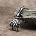 Macro detail of punk skull hand pendant in aged silver stainless steel on rock - Steel Color Pendant (Without Chain)