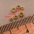Size comparison of 2mm, 2.5mm, and 3mm 18K gold-plated brass spacer beads on a ruler - 2mm/Aperture 1.3mm - Crimp Beads / 18K Gold