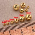 Dettaglio di perle tonde placcate oro 18k con righello in legno per creazioni di gioielli DIY - 2mm / Oro 18K