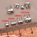 Macro shot of silver metal fold-over crimp beads in four sizes for DIY jewelry making - 1.5x4mm / White Gold