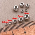Detailed size comparison of 18K gold plated textured spacer beads on a wooden ruler - 2.5mm Hole 1.0mm / White Gold