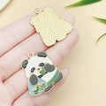 DIY cartoon panda alloy charm with green zongzi leaf design and golden metal finish - Panda Eating Zongzi (23039) / 29x25mm
