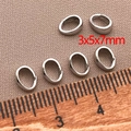 Detailansicht der 3x5x7mm silbernen Klemmschließen mit Lineal als Größenreferenz - Kleine Anhängerschlaufe 3x5x7mm / Platin