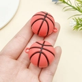 Handheld view of orange basketball pendants made of soft PVC for creative keychains - Red Basketball (22927)