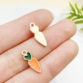 Hand holding a cute orange enamel carrot charm with green heart leaves for DIY jewelry - Orange Carrot (5x15mm) (9947)