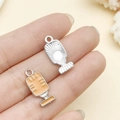 Orange microphone alloy pendant charm for DIY jewelry making shown in hand for size - Yellow Microphone (19442)