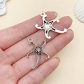 Starfish pendant in antique silver finish for DIY jewelry making shown on hand - Large Single Sided Starfish Style