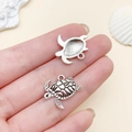 Antique silver sea turtle charms for jewelry making showing both sides of the pendant - Detailed Turtle Style