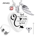 Close-up of heart urn necklace with engraving, red gemstone, wing charm and filling kit - January Birthstone