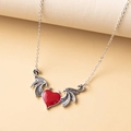 Detail of gothic devil wing necklace with red enamel heart pendant on textured background - Red