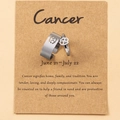 Cancer zodiac ring set with open band and charm on a kraft display card - Cancer