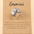 Detail view of Gemini zodiac ring set in silver steel on a vintage display card - Gemini