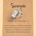 Detailed shot of Scorpio zodiac rings in polished silver on craft paper packaging - Scorpio