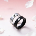 Detail of crown engraved stainless steel couple rings on a floral petal background - Crown Style Couple Rings (Style 8)