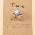 Detail of Taurus zodiac rings in silver steel with a themed description card - Taurus