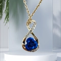 Infinity heart pendant necklace with blue rose and crystals on a white stand - Blue Rose