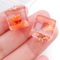 Pair of square resin flower pendants in orange-red hue with golden metal loop - Orange Cube (19183)