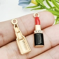 Macro view of gold-plated lipstick charms with red enamel and sparkling crystal accents - Black Enamel Rhinestone Lipstick 7x25mm (12480) 1g