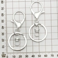 Silver lobster clasp keychain set with chain and ring on measurement grid background - Round Keychain with 8-shaped Buckle / 35x65mm / Bright Silver