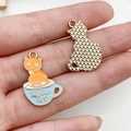 Cute kitten in blue cup alloy pendant with rose gold textured reverse and top loop - Orange Cat Blue Cup (19423)