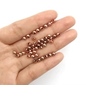 Rose gold CCB spacer beads held in hand for DIY jewelry making and bracelet crafting - Round Bead (18383)
