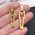 Par de colgantes de esqueleto dorado vintage para hacer joyas y manualidades de Halloween - Estilo de Figura de Esqueleto (20091) / 1 Unidad (9x39mm) / Oro antiguo