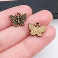 Colgante de mariposa de aleación bronce antiguo con alas caladas para bisutería DIY - Estilo Mariposa Bronce Antiguo (20155) / 13x11mm
