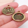 Colgante vintage de bronce con notas musicales y clave de sol para joyería artesanal - Nota Redonda (20903)