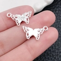 Conectores colgantes de mariposa hueca en aleación de plata para joyería DIY y pulseras - Estilo Mariposa Plata Brillante (20188) / 18x10mm