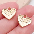 Gouden hartvleugel hangers voor DIY sieraden maken getoond op een vingertop voor maat - KC Gouden Hart Vleugels (19975)