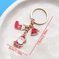 Golden Christmas keychain with Santa, stocking, and rhinestone hat charms on a tray - Santa Penguin Sock Nightcap Style (ER822)