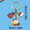 Christmas themed gold keychain featuring red Santa Claus and gift bag enamel pendants - Santa Hat Gift Bag Keychain (ER817)