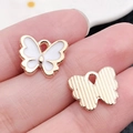 White and gold enamel butterfly charms for DIY jewelry making shown front and back - White 13x10.5mm (11862)