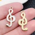 White enamel treble clef charm in golden alloy for DIY jewelry and earring making - Musical Note 21x9mm (19452)