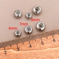 Three sizes of silver spacer beads with silicone inserts on a scale ruler measuring 6mm to 8mm - 8mm (Hole 2mm) / Platinum