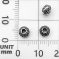Three vintage 8mm antique silver spacer beads with embossed rings on a measuring scale - Circle Spacer Bead (21069)