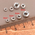 Close-up of 18K gold plated spacer beads in 4mm to 8mm sizes for DIY jewelry - 4mm / Thick Silver