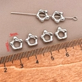 Macro shot of 18k gold plated star-shaped spacer beads with a ruler showing 9mm size - Platinum Long Lasting