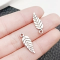 Antique silver leaf alloy pendant for DIY jewelry, shown held by fingers for scale - Antique Silver Leaf Style (10407)