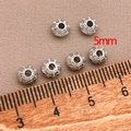 Detailed macro view showing 5mm silver saucer spacer beads with hollow patterns for DIY jewelry - 5mm / Thick UFO Spacer Bead (T562) / White Gold