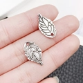 Antique silver leaf alloy pendant being held to show size for DIY jewelry making - Antique Silver Single-Sided Leaf Style (10414)