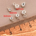 Vista macro di perle in rame argentato con nucleo in silicone in tre misure 3mm a 7mm - Perle di Arresto Con Occhiello (T117) / Argento (4mm Foro 0.8mm)