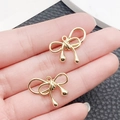 Ciondolo a fiocco dorato in lega di zinco per gioielli fai-da-te e accessori - Fiocco Avvolto (17x21mm)