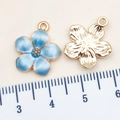 Blue enamel cherry blossom flower charm with gold metal finish and hanging loop detail - 14x16mm / Lake Blue