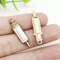 Enamel syringe charm for DIY jewelry making in gold and white finish on finger - White Enamel Rectangular Syringe (12005)