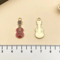 Guitar shaped charm for DIY jewelry with reddish brown enamel and golden plating - Red Guitar